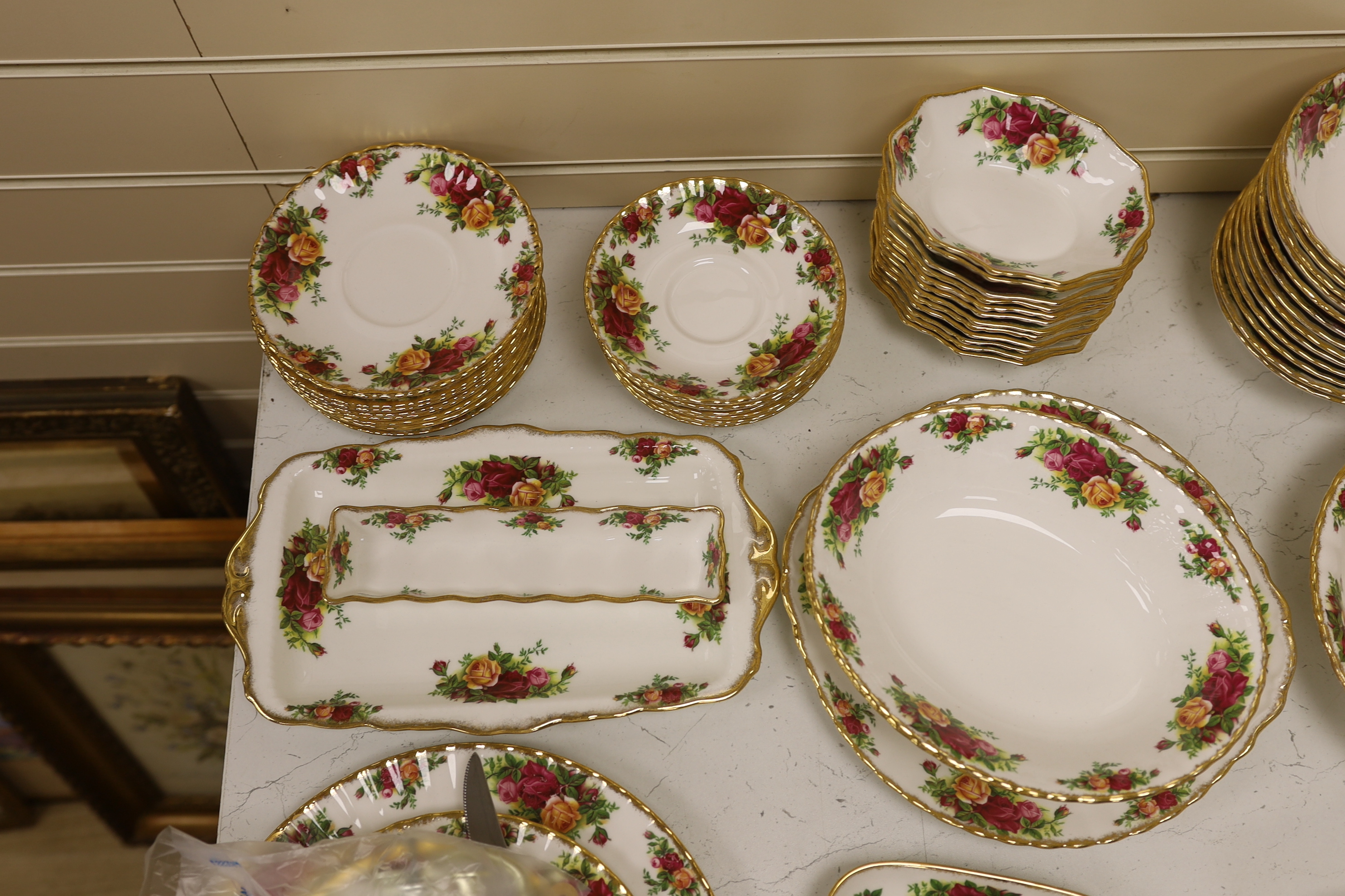 Royal Albert Old Country Roses, a large bone china service for twelve-place setting, and related accessories telephone, wall clock, table mats, napkins and cutlery.